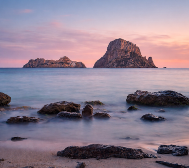 Vista de Es Vedrà desde Cala d’Hort al atardecer, uno de los paisajes más icónicos de Ibiza recomendado desde un hostal boutique en San Antonio Ibiza.